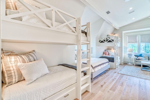 bedroom featuring lofted ceiling and light wood-type flooring