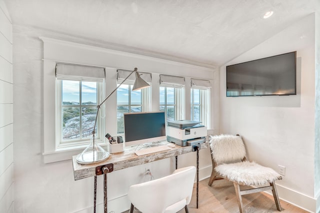 home office featuring hardwood / wood-style flooring, a healthy amount of sunlight, and vaulted ceiling