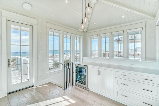 interior space featuring a water view, beverage cooler, beam ceiling, and wooden ceiling