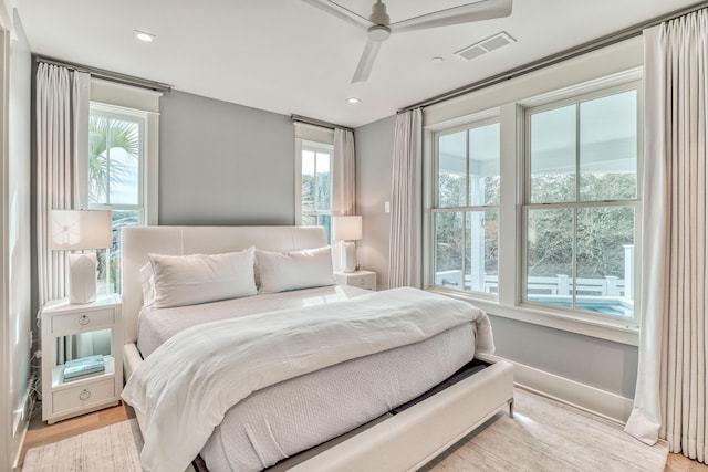 bedroom with ceiling fan and light hardwood / wood-style flooring