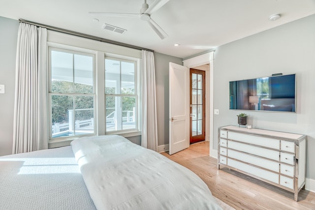 bedroom with ceiling fan and light hardwood / wood-style floors