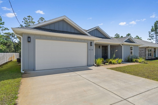 ranch-style house featuring cooling unit, a front lawn, and a garage