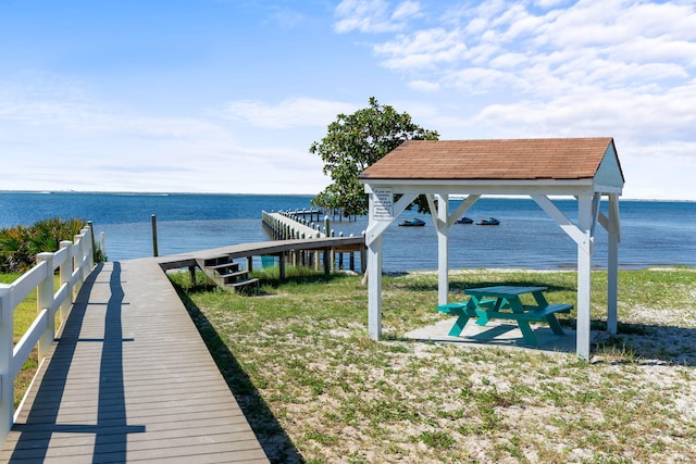 surrounding community with a gazebo, a yard, and a water view