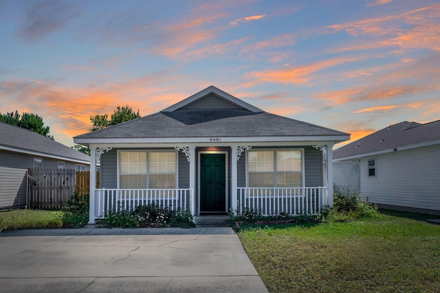 bungalow with a porch and a yard