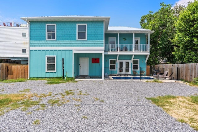 view of front of house featuring a patio and a balcony