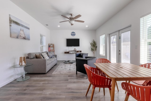 dining room with hardwood / wood-style floors, french doors, and ceiling fan