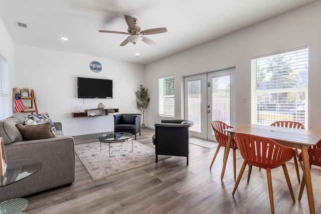 living room featuring french doors, wood-type flooring, and ceiling fan