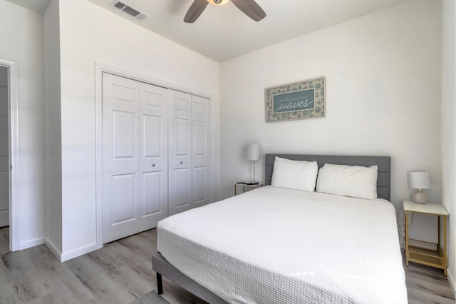 bedroom with light hardwood / wood-style flooring, a closet, and ceiling fan