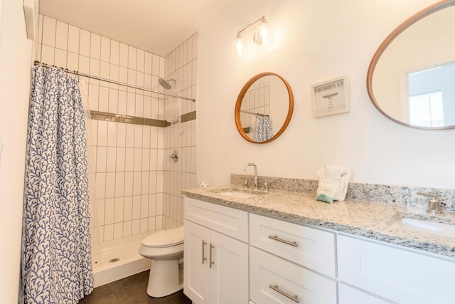 bathroom with toilet, curtained shower, vanity, and tile patterned flooring