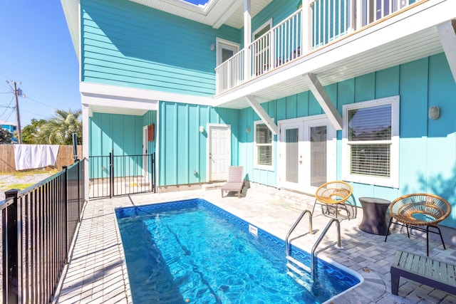 view of pool featuring french doors and a patio