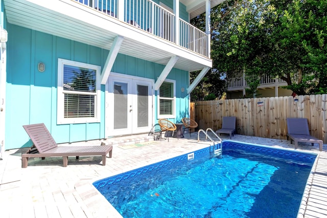 view of pool featuring french doors and a patio