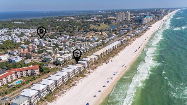 drone / aerial view featuring a water view and a beach view