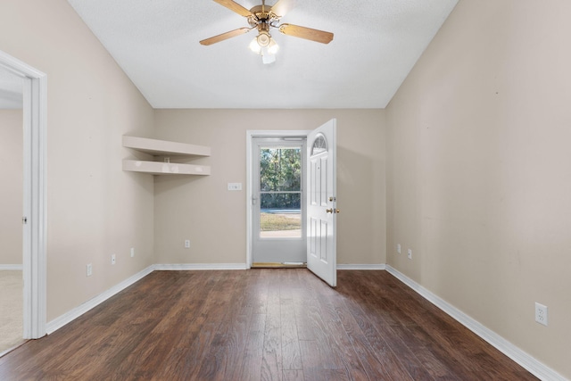 interior space with ceiling fan and dark hardwood / wood-style flooring