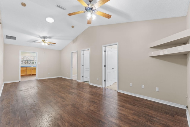 unfurnished living room with ceiling fan, dark wood-type flooring, and vaulted ceiling