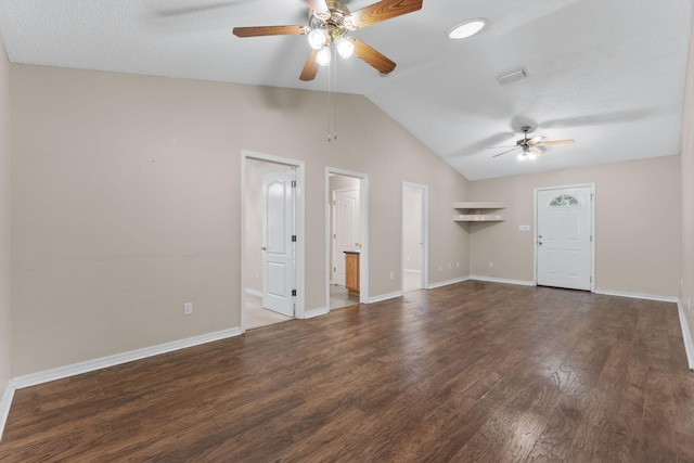 unfurnished living room with dark hardwood / wood-style floors, a textured ceiling, vaulted ceiling, and ceiling fan