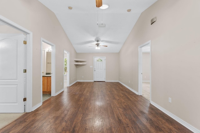 foyer with ceiling fan, vaulted ceiling, and dark hardwood / wood-style flooring