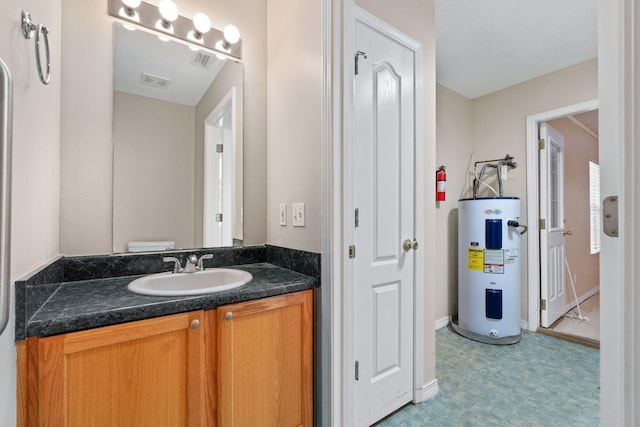 bathroom featuring vanity, electric water heater, and toilet