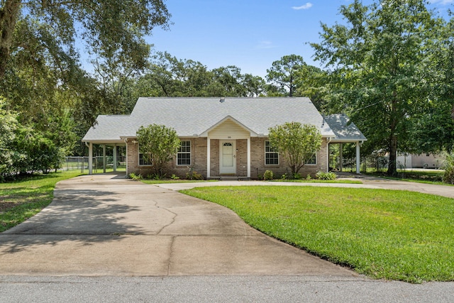 view of front of home with a carport and a front lawn