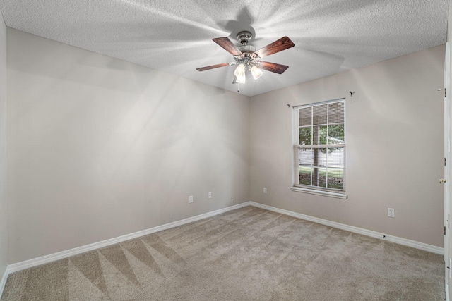 carpeted spare room featuring ceiling fan and a textured ceiling