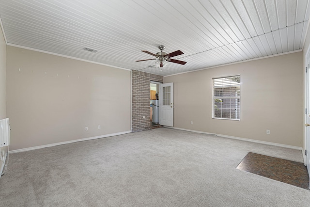 spare room with crown molding, carpet flooring, wood ceiling, and ceiling fan