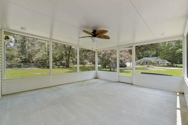 unfurnished sunroom featuring ceiling fan