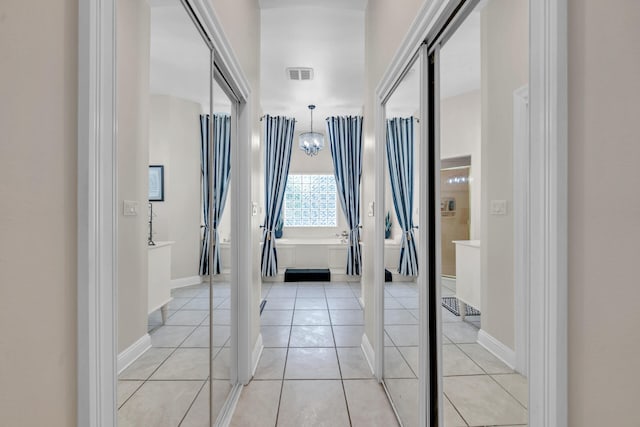 corridor with light tile patterned flooring