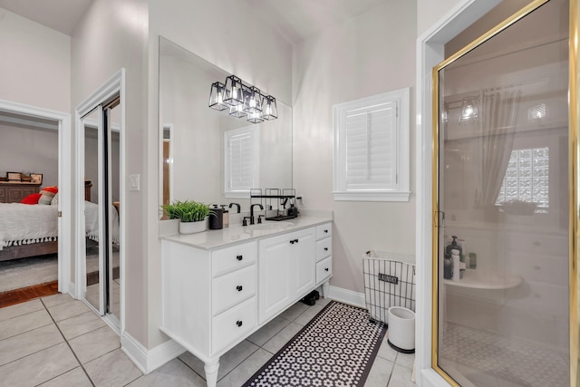 bathroom featuring vanity, an enclosed shower, and tile patterned flooring