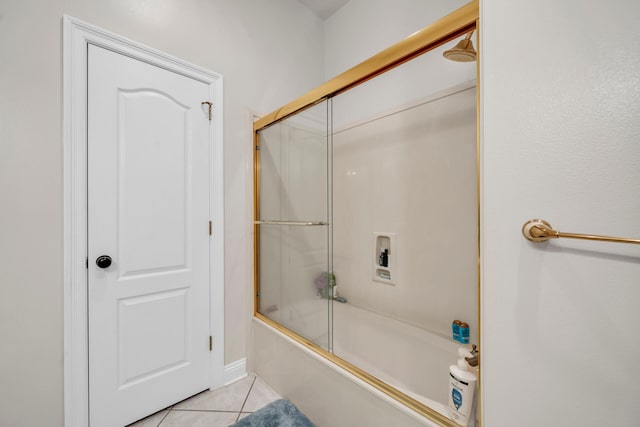 bathroom featuring bath / shower combo with glass door and tile patterned flooring