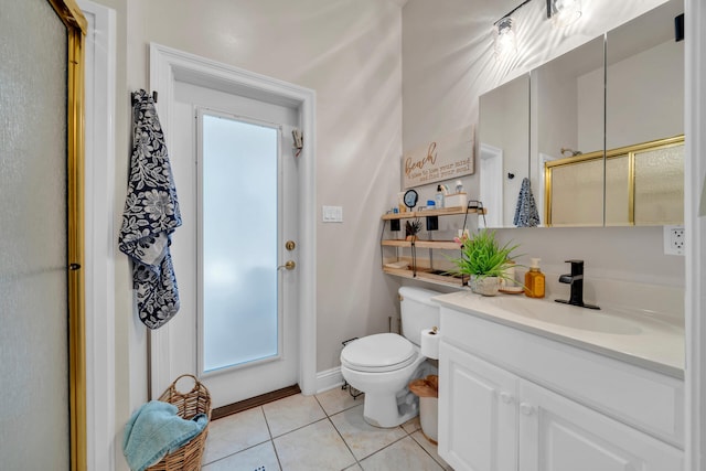 bathroom with vanity, toilet, tile patterned floors, and an enclosed shower