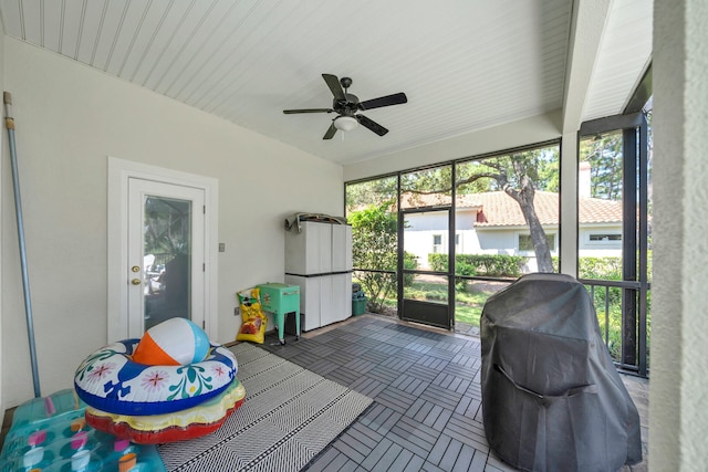 sunroom with beam ceiling and ceiling fan