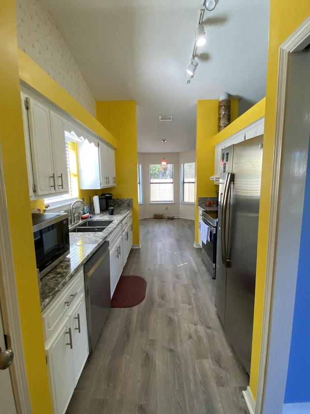 kitchen with white cabinetry, sink, and stainless steel appliances