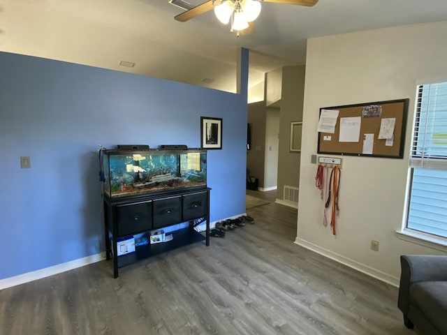 living room featuring lofted ceiling, wood-type flooring, and ceiling fan