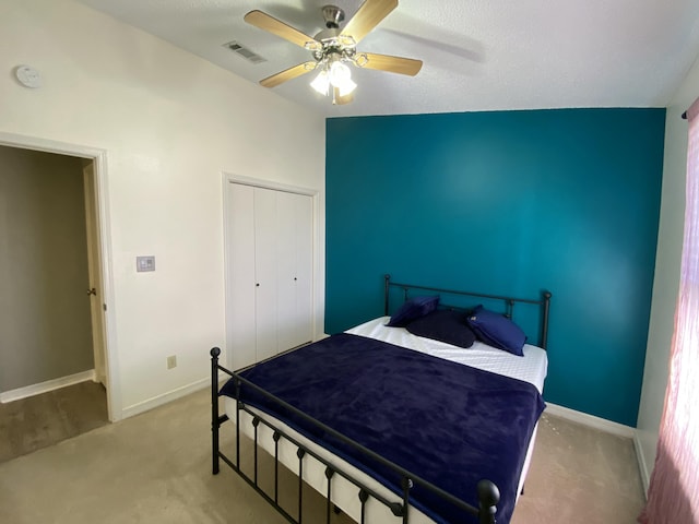 bedroom with light colored carpet, a closet, and ceiling fan