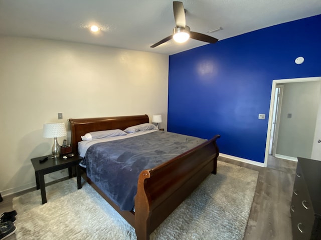 bedroom featuring dark hardwood / wood-style flooring and ceiling fan