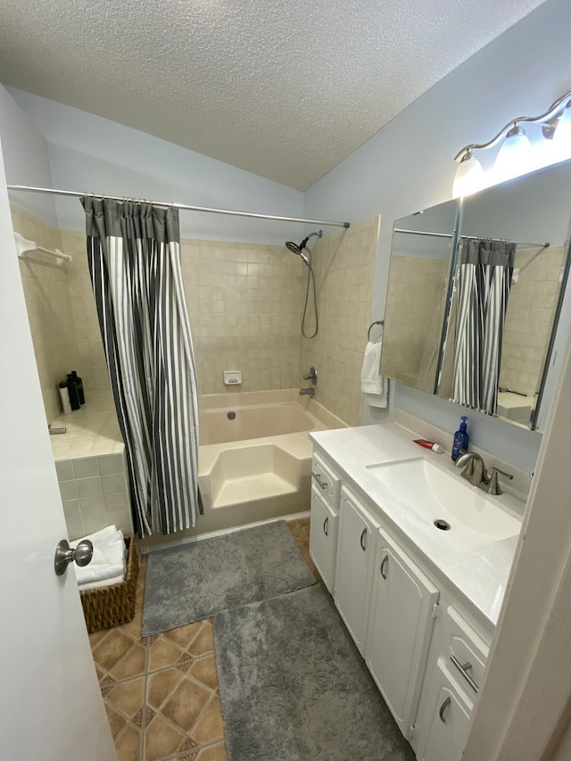 bathroom featuring tile patterned floors, shower / tub combo, vanity, and a textured ceiling