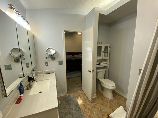 bathroom featuring vanity, tile patterned floors, and toilet