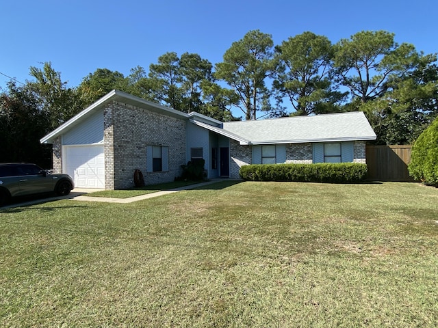 view of front of property with a garage and a front lawn