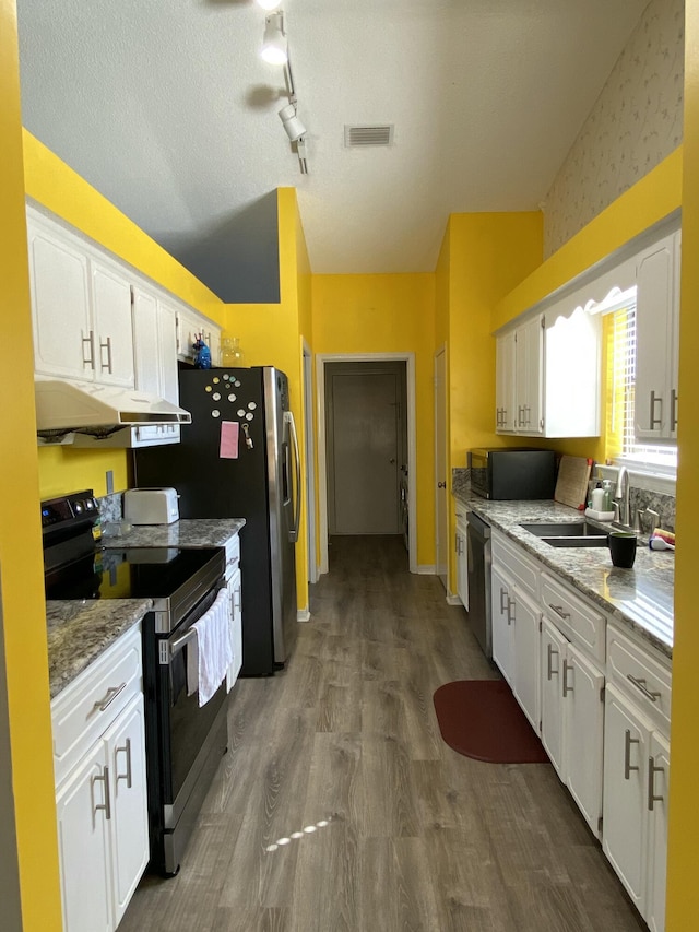 kitchen featuring sink, electric range, and white cabinets