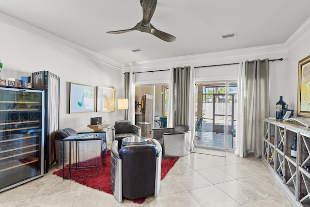 tiled living room with ceiling fan, wine cooler, and ornamental molding