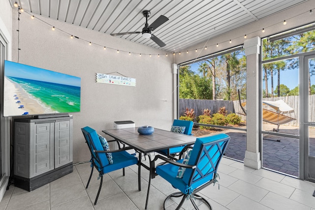 sunroom featuring ceiling fan and wood ceiling