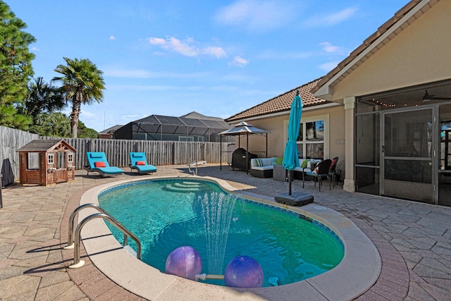 view of pool with ceiling fan and a patio area