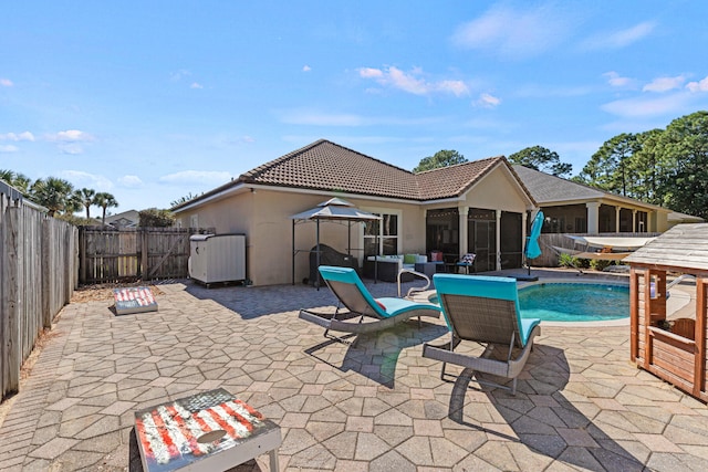 view of pool with a patio and a sunroom