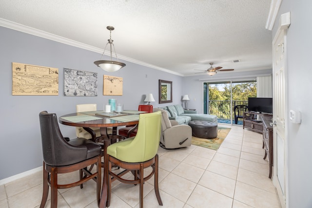 dining room featuring ornamental molding, a textured ceiling, light tile patterned floors, and ceiling fan