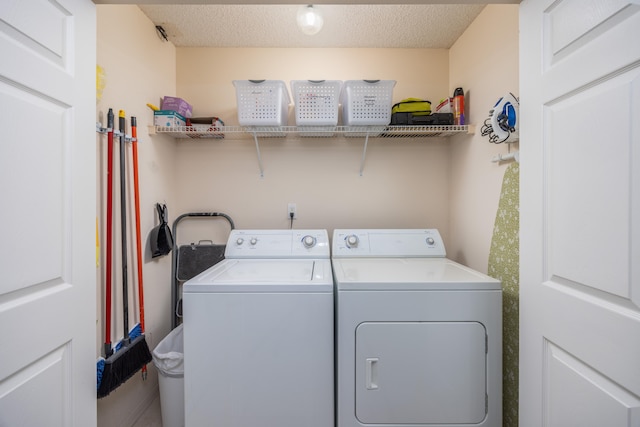 laundry room featuring independent washer and dryer and a textured ceiling