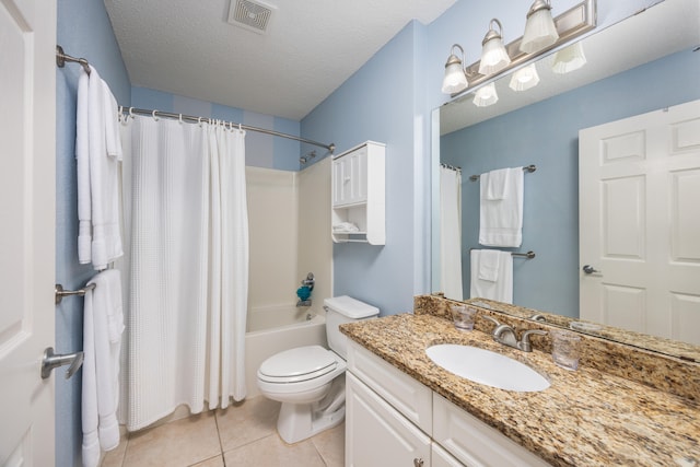 full bathroom featuring tile patterned floors, shower / bath combo, toilet, vanity, and a textured ceiling