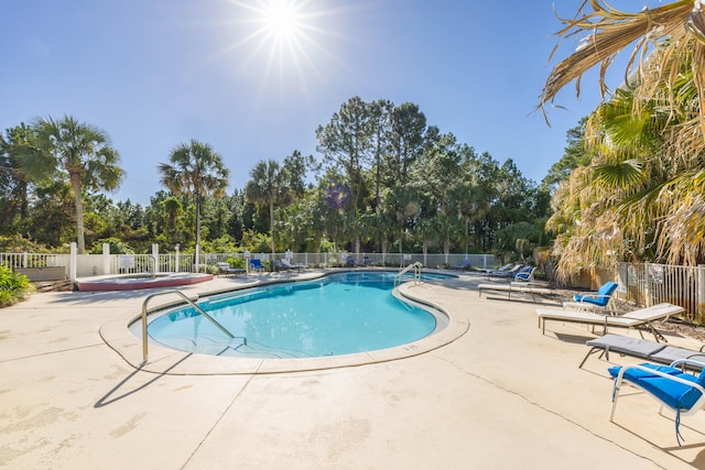 view of swimming pool with a patio