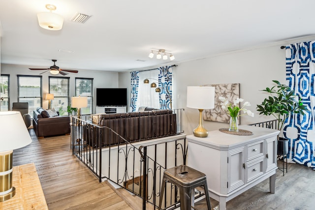 living room with ceiling fan and light hardwood / wood-style flooring