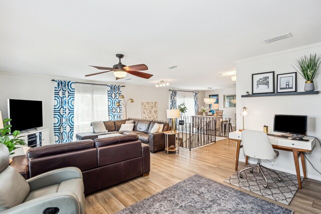 living room featuring wood-type flooring and ceiling fan