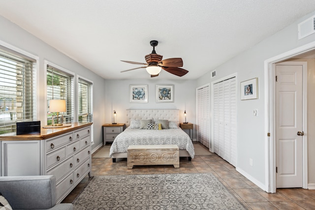 bedroom featuring light tile patterned flooring, a textured ceiling, and ceiling fan