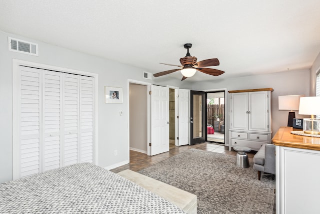 bedroom featuring a textured ceiling, light tile patterned floors, and ceiling fan